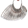 A group of silver metal bangle sizing rings hanging clustered together on a wire loop.
