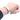 A metal bracelet measuring band wrapped around a person's wrist to check circumference size.