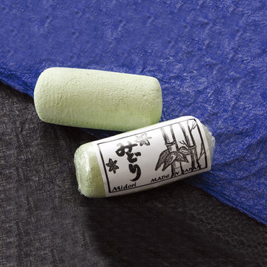 Crossed Midori green polishing bars for high-luster finishing on precious metals.