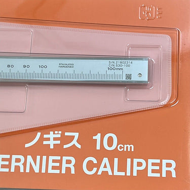 Detailed view of the Mitutoyo vernier scale, 100mm capacity, and laser-etched serial number.