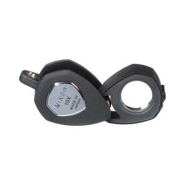 Nikon 10X triplet jewelers loupe shown at an angle with the lens partially swiveled out of its protective black frame.