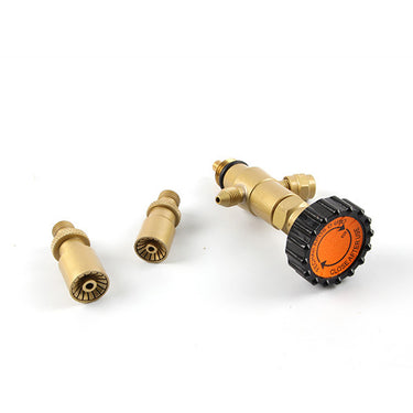 Close-up of the gas valve regulator with an orange dial label next to two precision brass burner tips