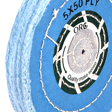 Side profile of an ORO blue muslin buff showing the thick fabric layers and chemically treated edges.