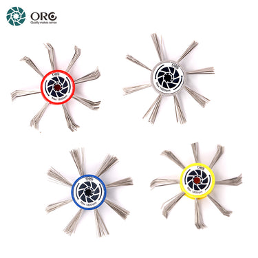 An overhead layout of four colorful ORO MaxiMat satin finishing wheels with straight and bent steel wire pins.
