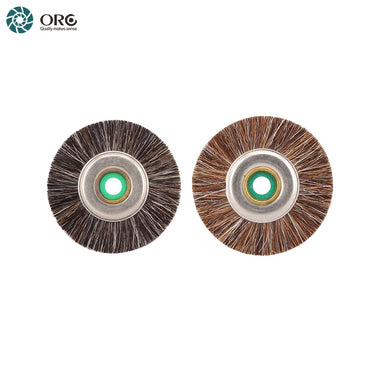 A dark horsehair brush and a light brown bristle wheel side-by-side, both featuring central metal centers.