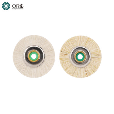 Side-by-side view of a white goat hair brush and a cream bristled mini polishing wheel with metal hubs.