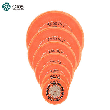 Stacked ORO orange muslin buffs showing a wide range of 50-ply diameters for professional metal finishing.