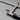 Close-up detail of the lower thumbscrew blade clamp assembly directly above the black handle ferrule.