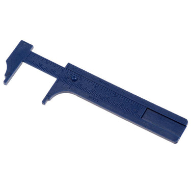 An open blue plastic vernier caliper lying flat, showing the raised inch and meter marking details.