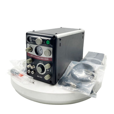 GraverMach AT pneumatic jewelry engraver system displayed with packaged accessories and pedal.