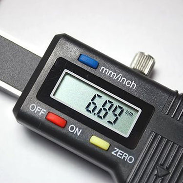 Close-up of the black plastic housing and LCD screen of a mini jewelry caliper showing a 6.89mm value.