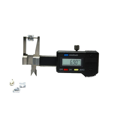 An electronic pocket gemstone gauge measuring a loose diamond next to a cluster of small unset stones.