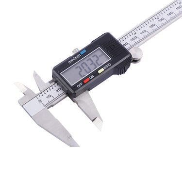 Close-up view of a precision steel digital caliper showing an active display reading of 20.32 mm.