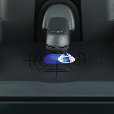 Macro shot of a loose colorless diamond being screened inside the Presidium SDS II.