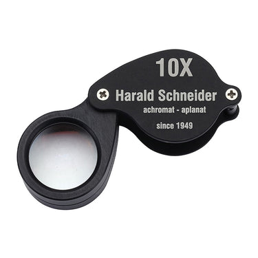 Top-down view of the Harald Schneider L1 loupe showing the 10x magnification and achromat-aplanat markings.