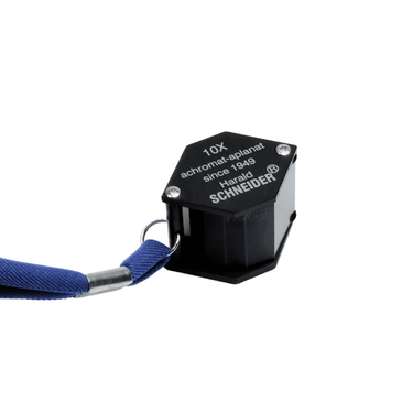 Angled view of a closed Harald Schneider LS 10 loupe, showcasing its compact hexagonal black housing.