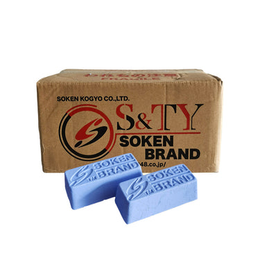 A stack of Soken blue solid polishing compound boxes for industrial metal finishing.