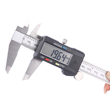 Close-up of a stainless steel digital caliper indicating an internal jaw measurement of 19.64 mm.