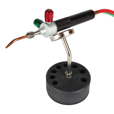 A miniature jewelry soldering torch held securely on the Stuccler magnetic stand mount.