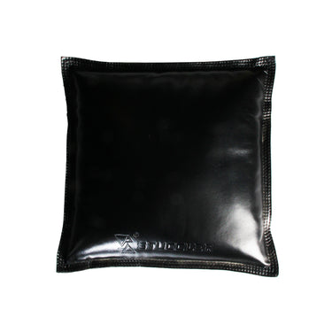 Direct overhead shot of a square black leather Stuccler sandbag pad with an embossed logo.
