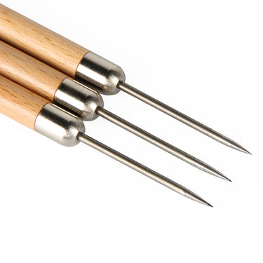 Detailed close-up view of the sharp titanium needle tips and metal ferrules of three soldering picks