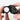 SwissAxe Triplet Hawk 10X loupe held between fingers to show its ergonomic grip for diamond inspection.