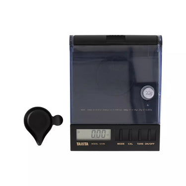 Top down view of Tanita 1210N carat scale showing gem tray and 20g calibration weight.