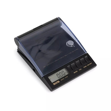 Angled view of Tanita 1210N diamond scale with protective cover and digital display.