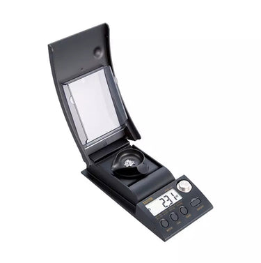 Tanita 1230 diamond scale showing 2.31ct reading while weighing gems in a black tray.