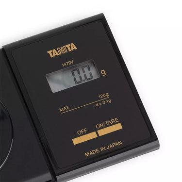 Close-up of TANITA 1479V digital display showing 0.1g precision and Made in Japan label.