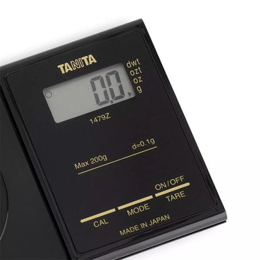 Close-up of Tanita 1479Z digital display showing 0.0g and weight unit options.