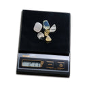Tanita KP-400M scale measuring small polished gemstones with a 21.1g digital readout.