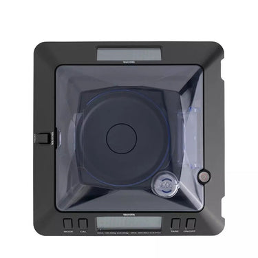 Overhead view of the Tanita KP-601 showing the circular weighing pan and the integrated leveling bubble.