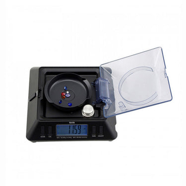 Tanita KP-601 scale measuring loose gemstones with the digital readout set to carat (ct) mode.