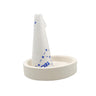 Technique ASIC borax cone flux stick standing in a round ceramic grinding dish for jewelry soldering preparation.