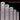 Row of five thick stainless steel rulers standing vertically to showcase different size specifications.