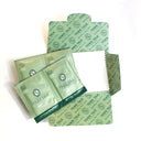 Town Talk Pearl Care Tissues, individually packaged in green foil packets and an open cardboard sleeve, designed for cleaning delicate pearls.
