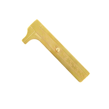 Angled overview of a vintage-style TSK brass sliding gauge vernier caliper on a white background.