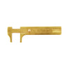 overhead view of a TSK brass vernier caliper tool with its measuring jaws opened to show the metric scale.
