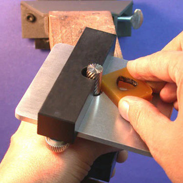 Jeweler using the WOLF TOOLS adjustable trimmer to shape a piece of yellow carving wax.