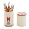 A set of 8 Wolf Micro Carvers in a white branded container with the wooden lid set to the side.