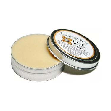 Open tin of Wolf Touch-Up wax showing smooth yellow carving wax with the product lid resting beside it.