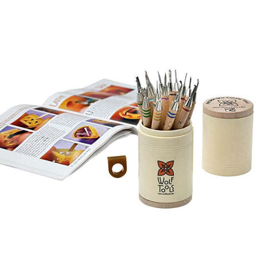 Wolf wax carving tools set next to an open instructional technique book.
