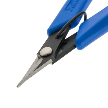 Angled view of Xuron scissor blades highlighting the precision edge and durable metal construction.