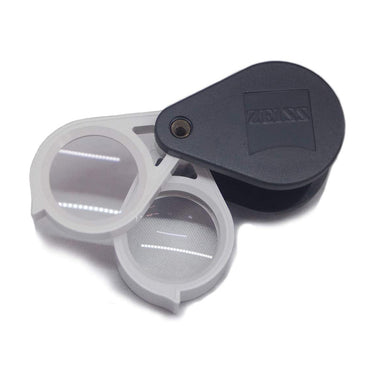 Zeiss D36 magnifier with both 3x and 6x lenses extended to achieve a combined 9x magnification power.