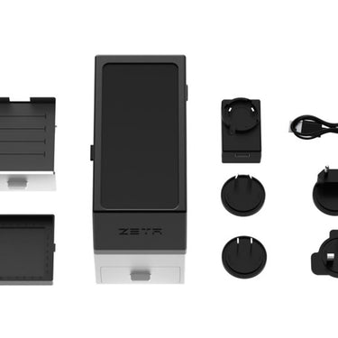 ZETA scanner, adapters, and power cords spread out on a white background.